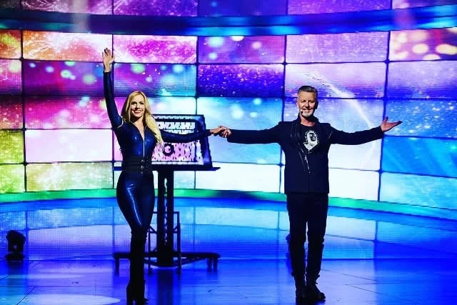John Taylor on a brightly lit television performance stage