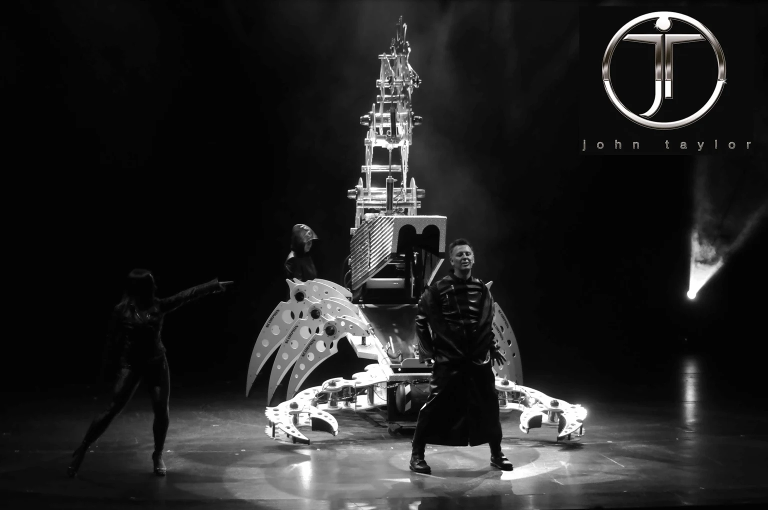 Black-and-white photograph of John Taylor and performers beside the Scorpion stage illusion