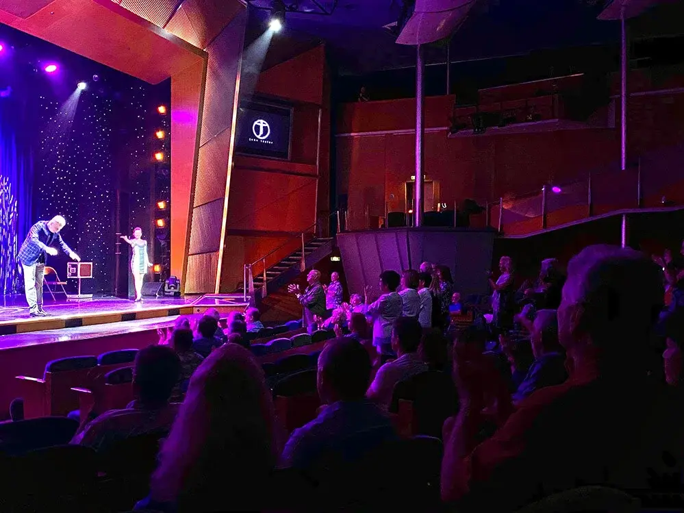 John Taylor receiving a standing ovation in a theatre